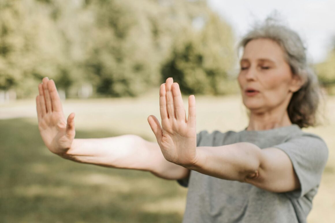 Starija žena vježba Tai Chi na otvorenom